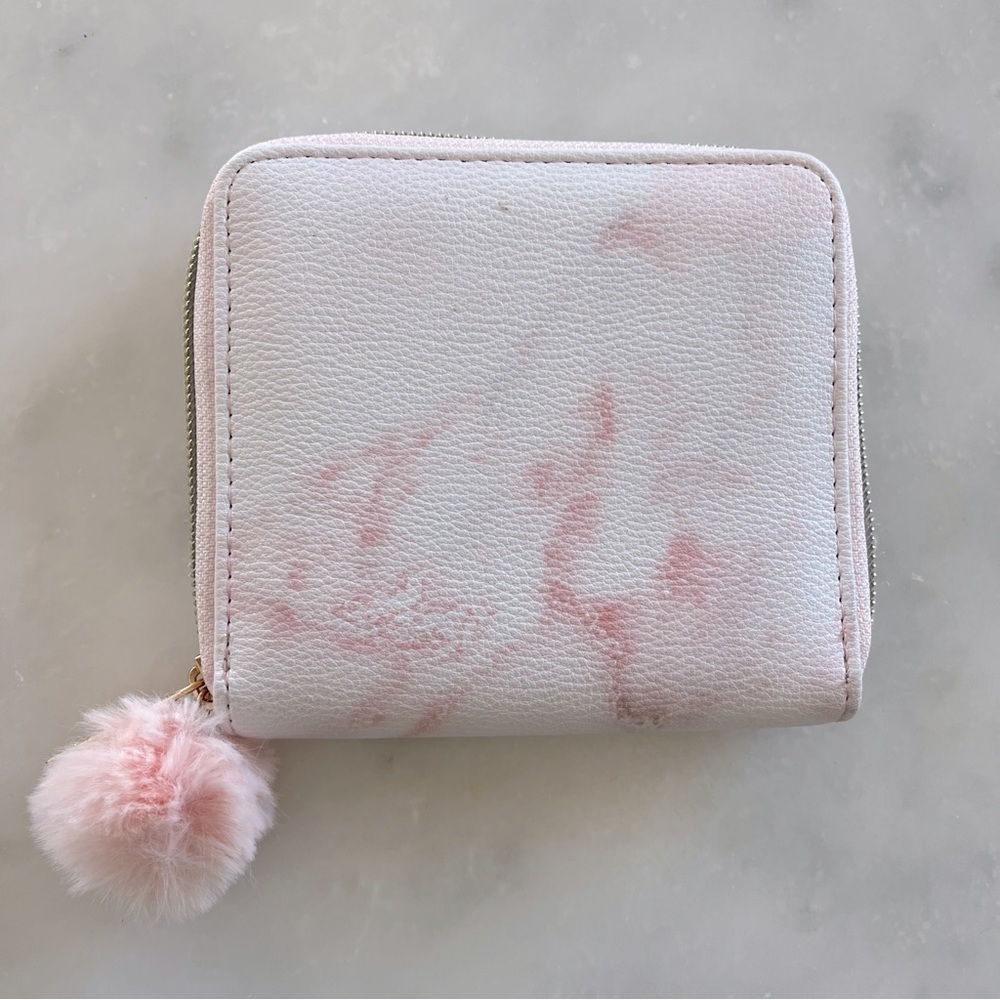 Claire’s pink tie dye wallet with pom pom zipper.